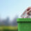 Woman putting blister packs and expired medicines in the trash bin, safe disposal of expired medications